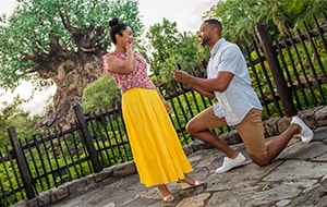 A man proposing to a woman in front of the Tree of Life at Disney’s Animal Kingdom park