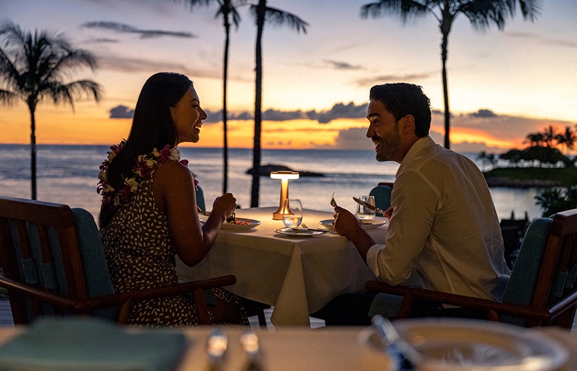 A couple dining on the patio at Ama Ama, Contemporary Island Cooking A couple dining on the patio at Ama Ama, Contemporary Island Cooking