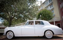 A vintage Rolls Royce parked on a boardwalk ready for an elegant wedding at Walt Disney World Resort 