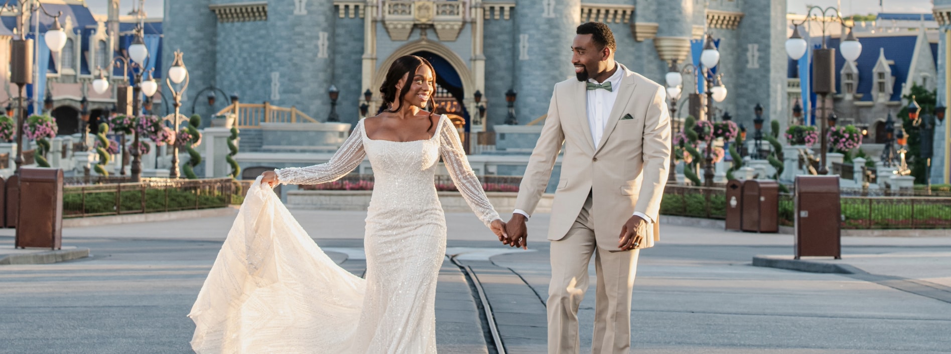 A vow renewal couple walking hand in hand near Cinderella Castle at Magic Kingdom park