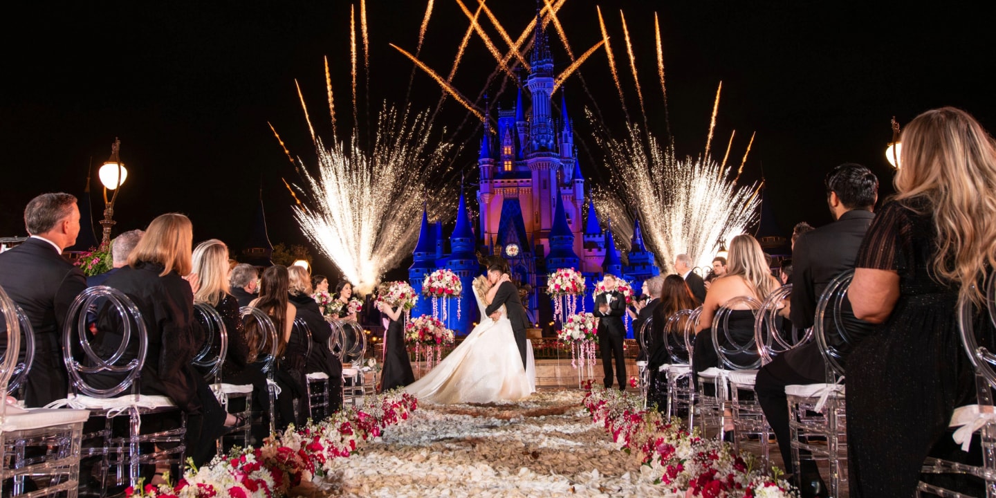 A bride and groom celebrating their first kiss during an After-Hours Ceremony at Magic Kingdom Park
