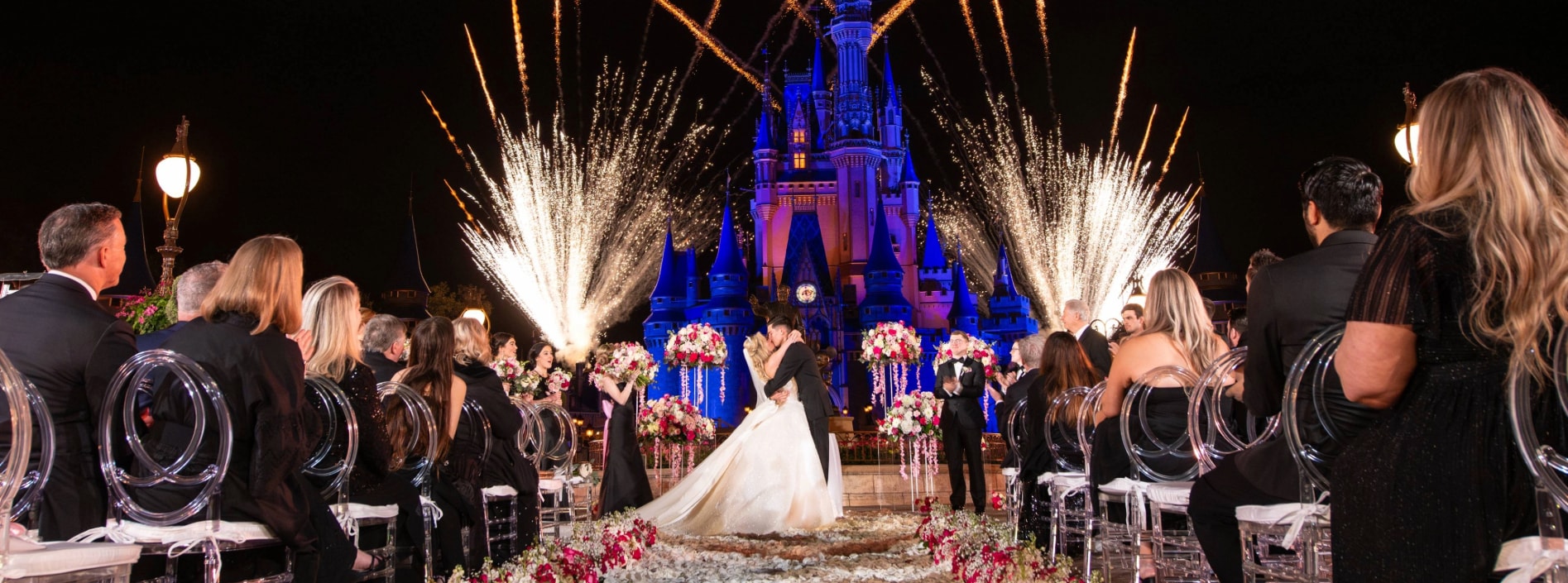 A bride and groom celebrating their first kiss during an After-Hours Ceremony at Magic Kingdom Park A bride and groom celebrating their first kiss during an After-Hours Ceremony at Magic Kingdom Park
