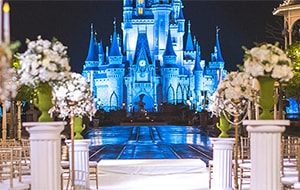 Rows of chairs and flowers arranged for a wedding ceremony with a castle as the backdrop