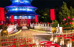A wedding ceremony setting decorated with candles and an aisle of rose petals at the China Pavilion