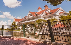 A shady brick path with a cast iron guardrail and old fashioned streetlamps looks out to the Seven Seas Lagoon and Disney's Grand Floridian Resort & Spa A shady brick path with a cast iron guardrail and old fashioned streetlamps looks out to the Seven Seas Lagoon and Disney's Grand Floridian Resort & Spa
