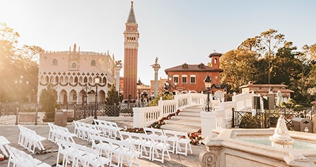 A wedding reception setup in a courtyard amid the Italian style buildings of Italy Isola in Epcot