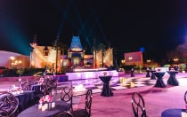 Tables, chairs, a dance floor and stage in front of Grauman's Chinese Theatre in Disney's Hollywood Studios