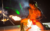 A Hawaiian performer dances with his fire stick