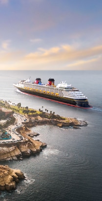 An aerial view of La Jolla Cove with a Disney cruise ship sailing along the coastline in California An aerial view of La Jolla Cove with a Disney cruise ship sailing along the coastline in California