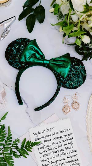 An assortment of items, including stylish women’s sandals, a diamond ring, earrings, flowers, Minnie ears and a hand fan An assortment of items, including stylish women’s sandals, a diamond ring, earrings, flowers, Minnie ears and a hand fan