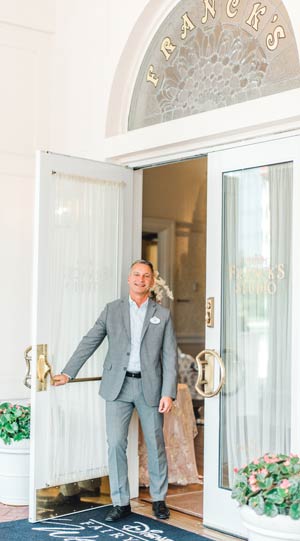 A man holds open the door to Franck’s Bridal Studio at Walt Disney World Resort A man holds open the door to Franck’s Bridal Studio at Walt Disney World Resort