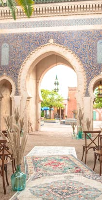 Chairs arranged for an outdoor wedding face the iconic arch at the entrance to the Morocco Pavilion at EPCOT Chairs arranged for an outdoor wedding face the iconic arch at the entrance to the Morocco Pavilion at EPCOT