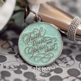 A glittery charm that says 'faith, trust and pixie dust', attached to a metal bouquet holder