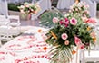 A Disney wedding ceremony venue with floral arrangements, chairs and an aisle runner strewn with flower petals