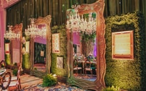 Three crystal chandeliers hanging in front of 3 ornate full length mirrors separated by wall art for a custom vision