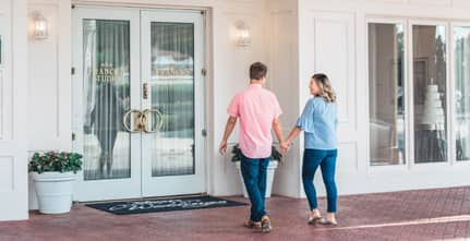 A couple walks toward the doors to Franck’s Studio