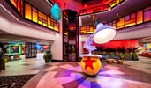A hotel atrium with a sculpture of Luxo Junior balancing on a ball