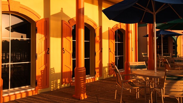 An outdoor seating area with tables and umbrellas