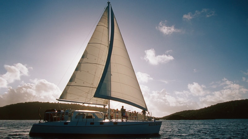 A sailboat off the coast of a Caribbean island