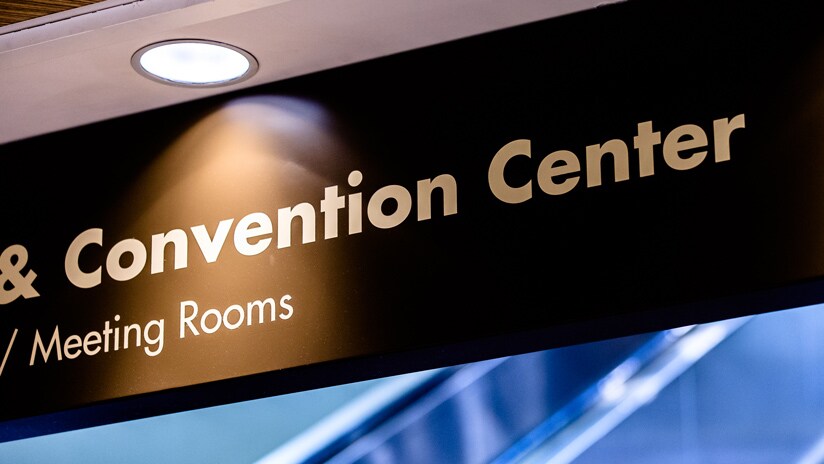 A portion of a lit sign that reads Convention Center and Meeting Rooms