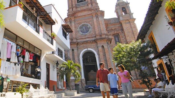 A family walks along the streets of Puerto Vallarta, Mexico