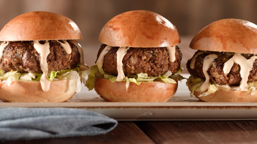 3 meatball sliders on a rectangular plate