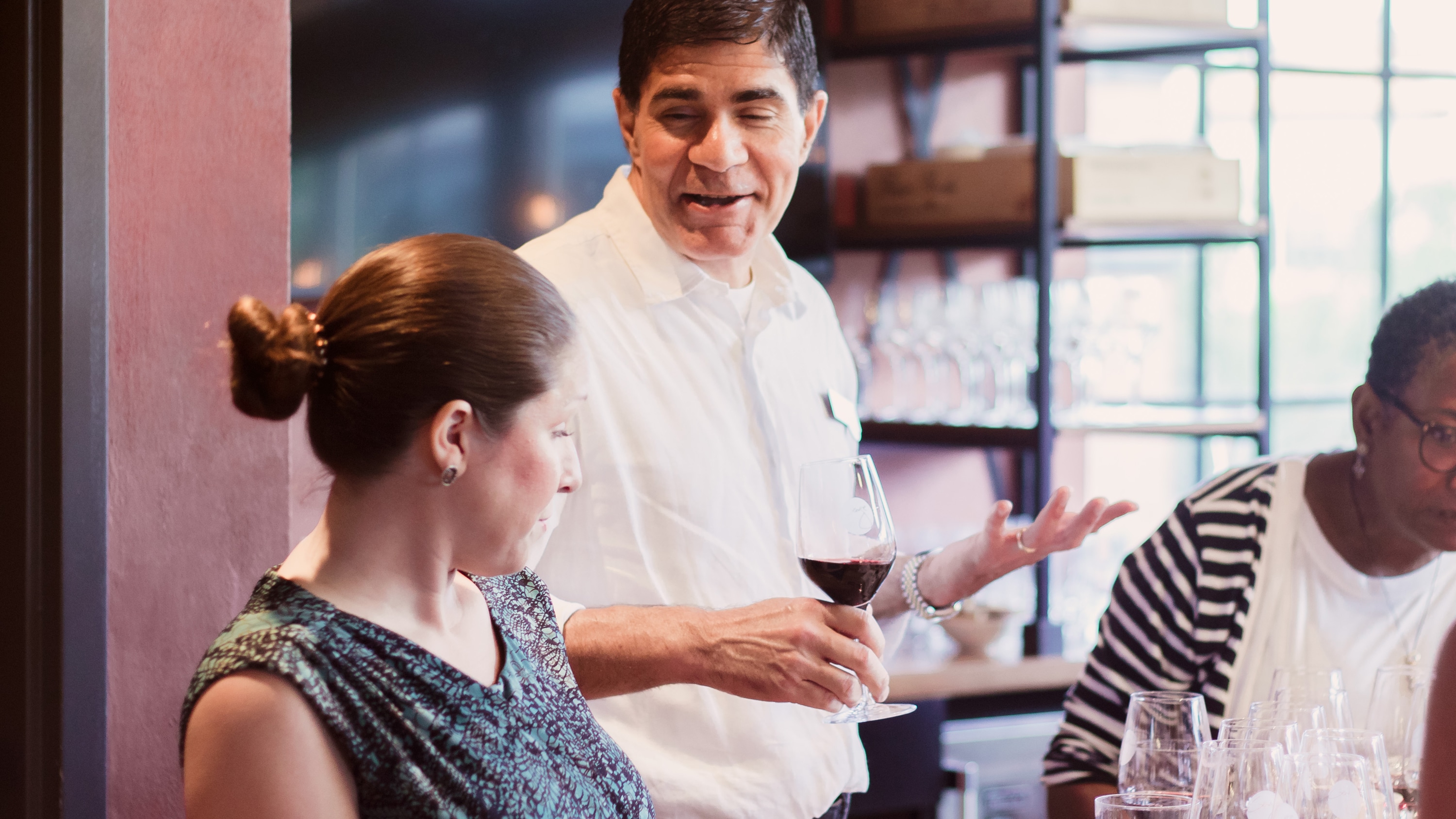 Master Sommelier George Miliotes has a conversation with a Guest at Wine Bar George Master Sommelier George Miliotes has a conversation with a Guest at Wine Bar George