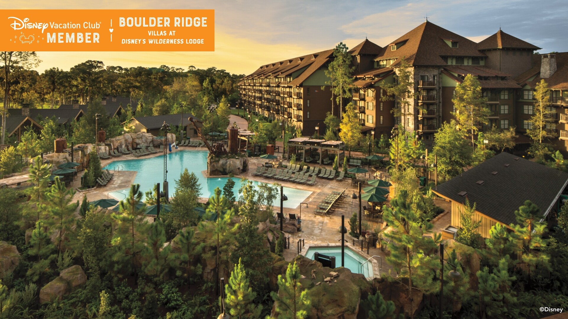 A large pool and the Boulder Ridge Villas, over which a banner reads, ‘Disney Vacation Club Member, Boulder Ridge Villas at Disney’s Wilderness Lodge’
