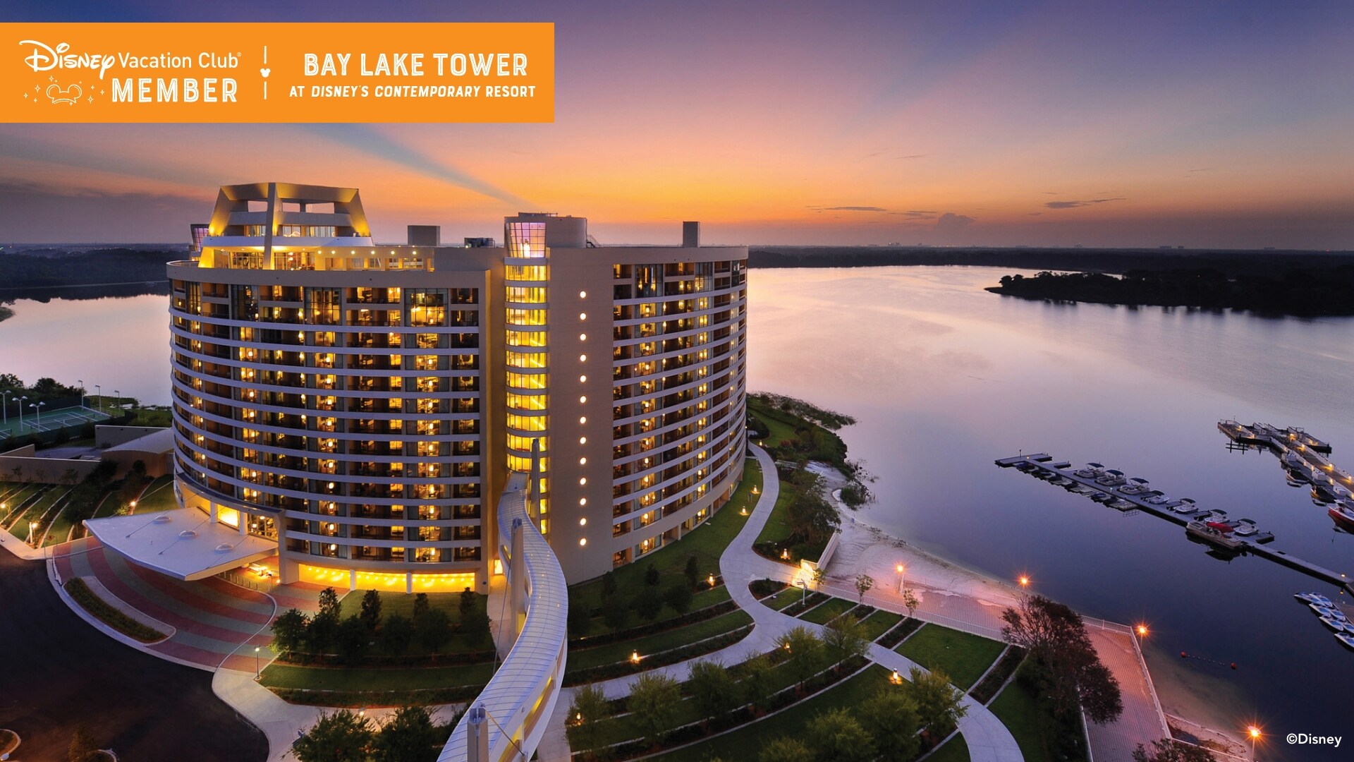 Bay Lake Tower, brightly lit at dusk, and Bay Lake, over which a banner reads, ‘Disney Vacation Club Member, Bay Lake Tower at Disney’s Contemporary Resort’