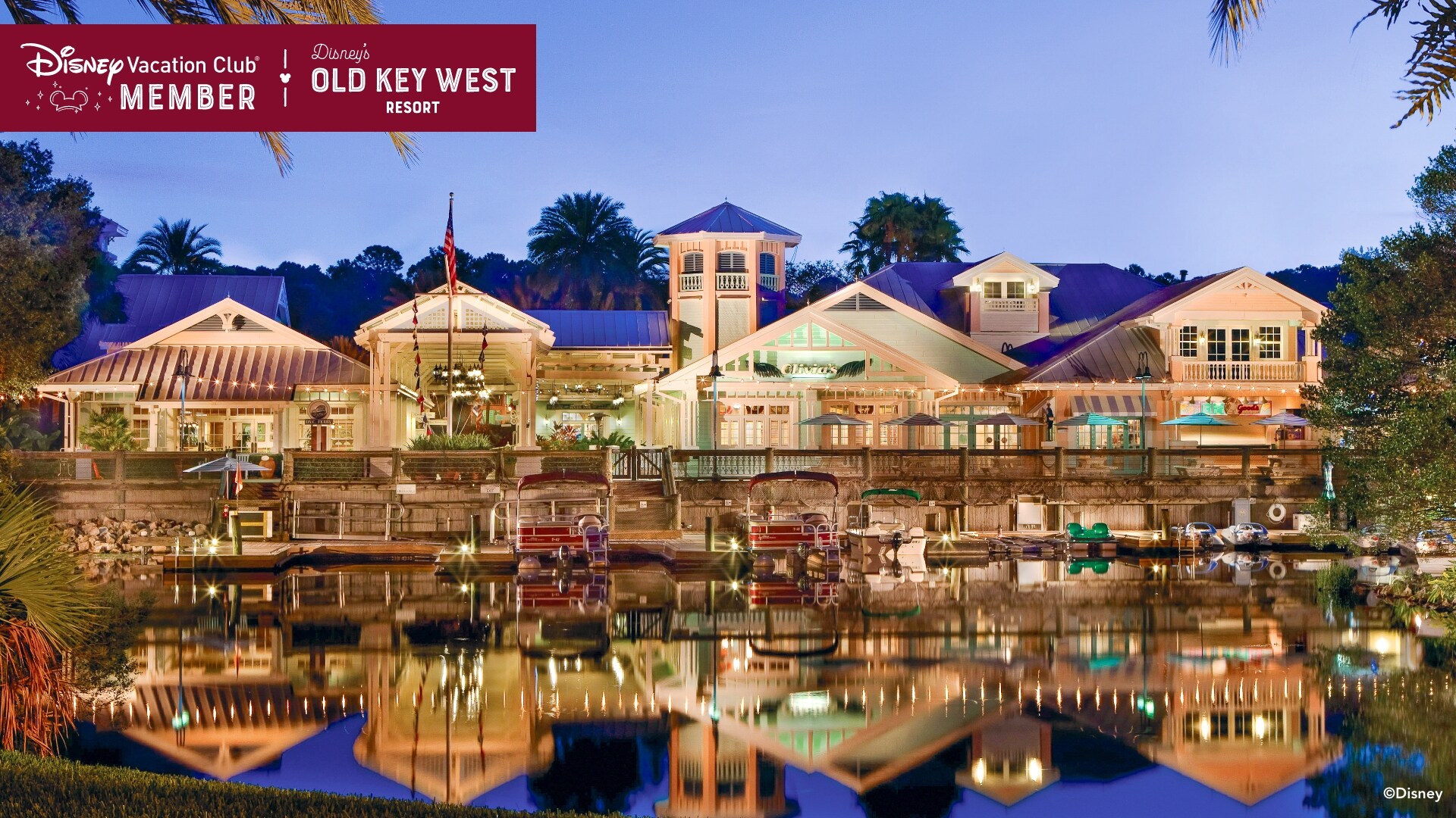Disney’s Old Key West Resort, with the water in front of it, over which a banner reads, ‘Disney Vacation Club Member, Disney’s Old Key West Resort’
