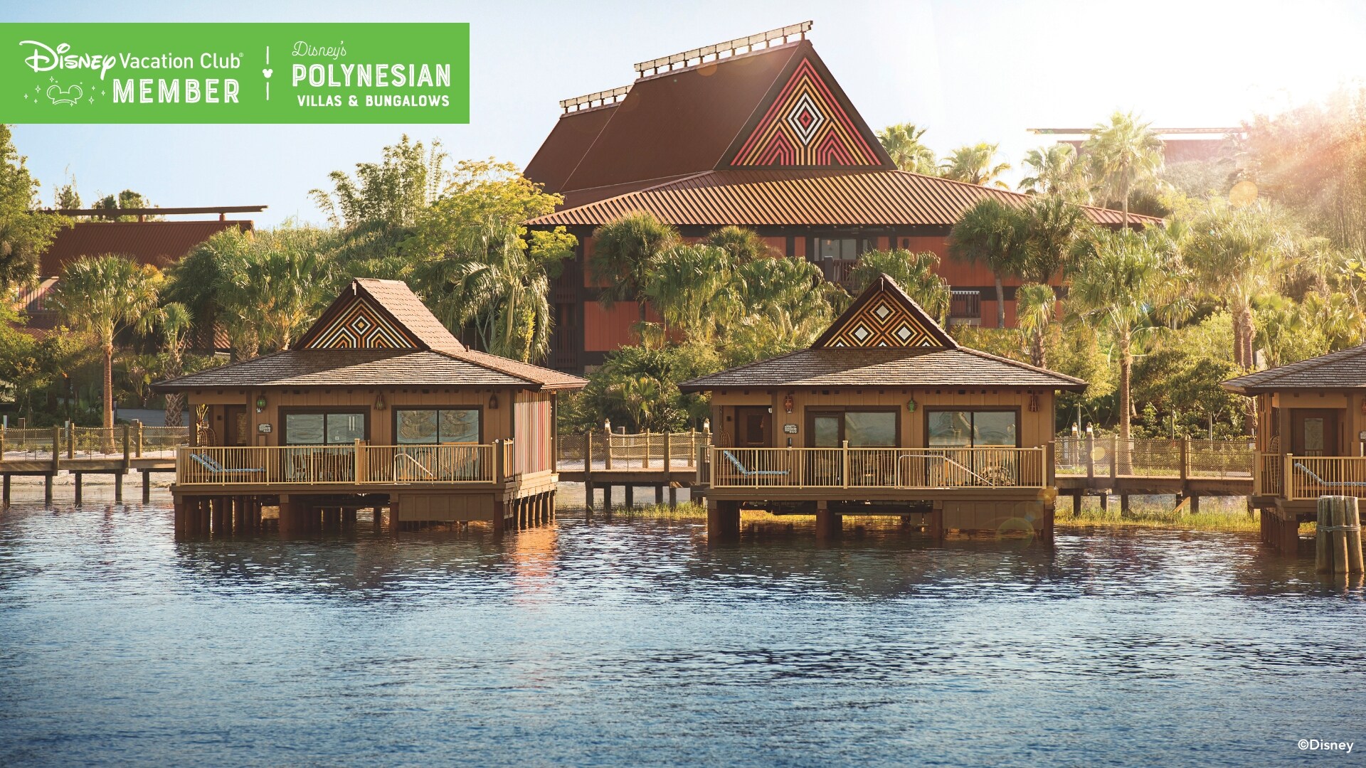 The waterfront, Bungalows and buildings of Disney’s Polynesian Villas and Bungalows, over which a banner reads, ‘Disney Vacation Club Member, Disney’s Polynesian Villas and Bungalows’