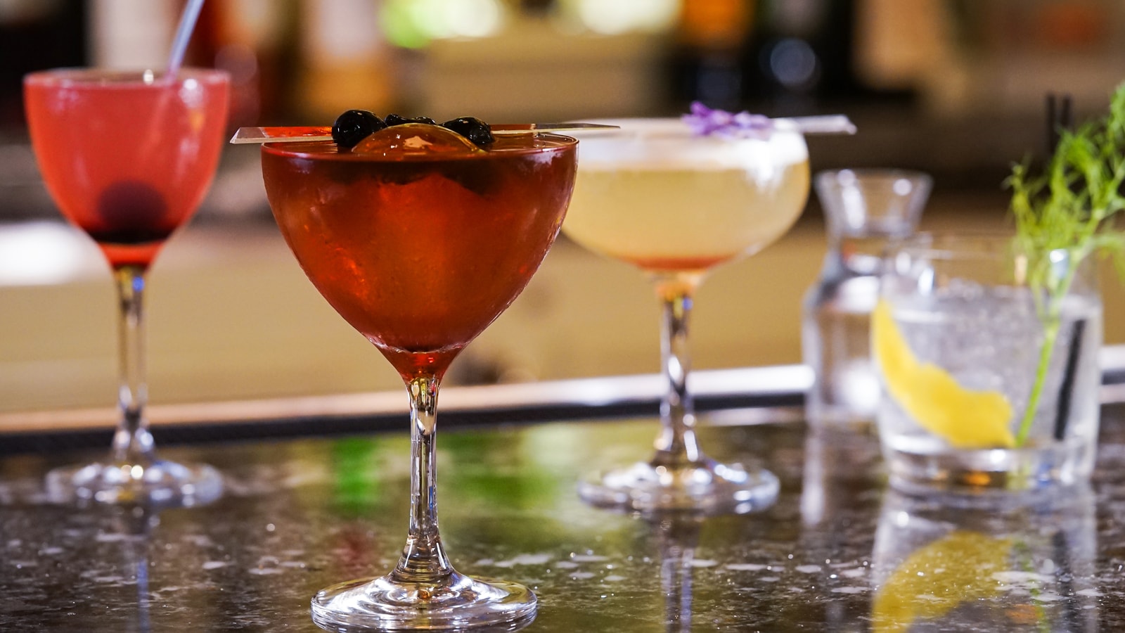 4 cocktails on a bar top
