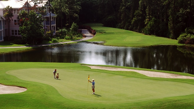 A golfer lining up a putt on a golf course