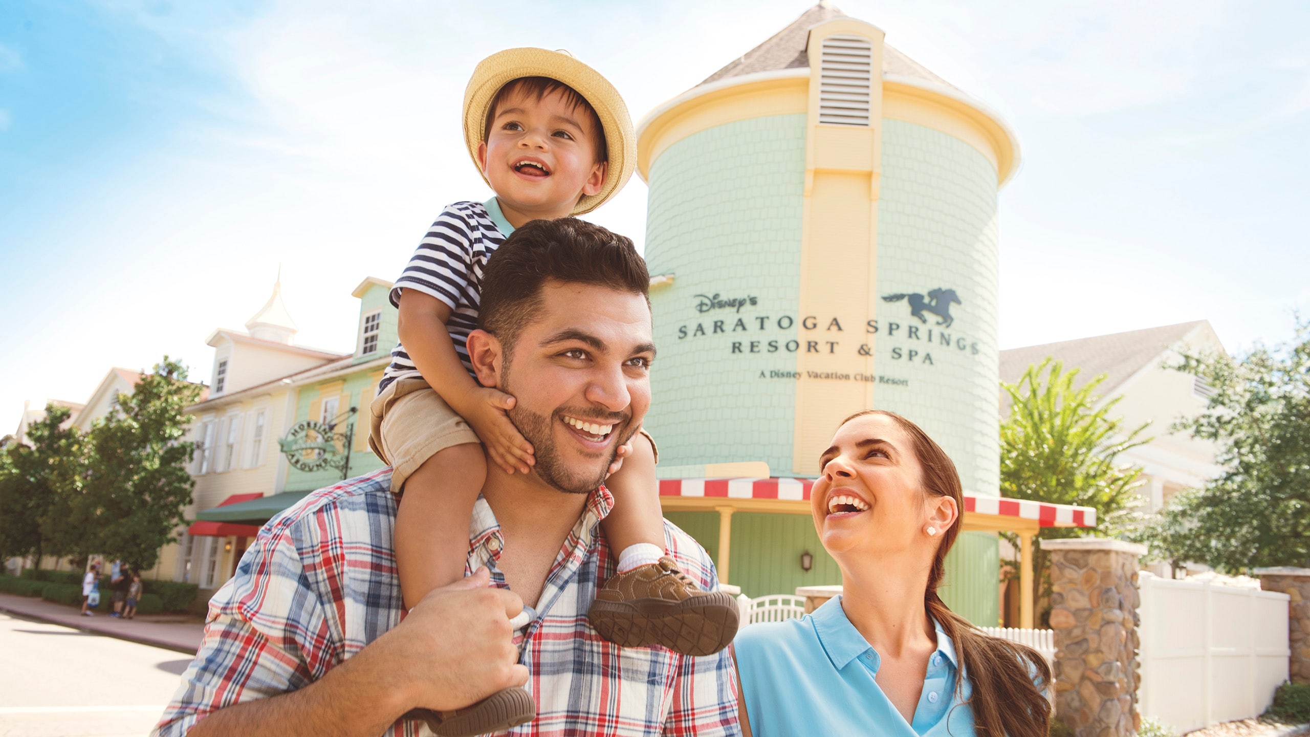 A man, woman and little boy walking outside at Disney's Saratoga Springs Resort & Spa