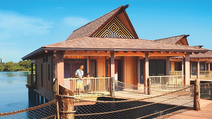 A father and son on the front porch of a Bungalow at Disney's Polynesian Villas & Bungalows in Florida