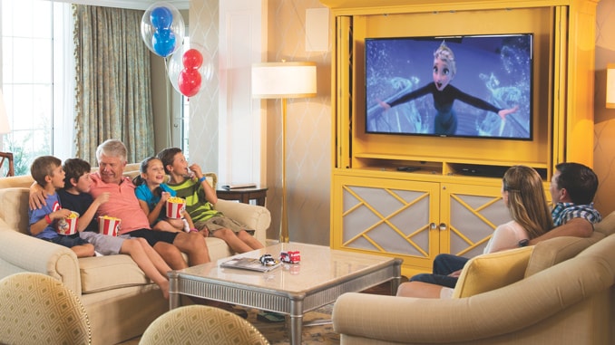 A family of 7 on 2 couches, watching the Disney film