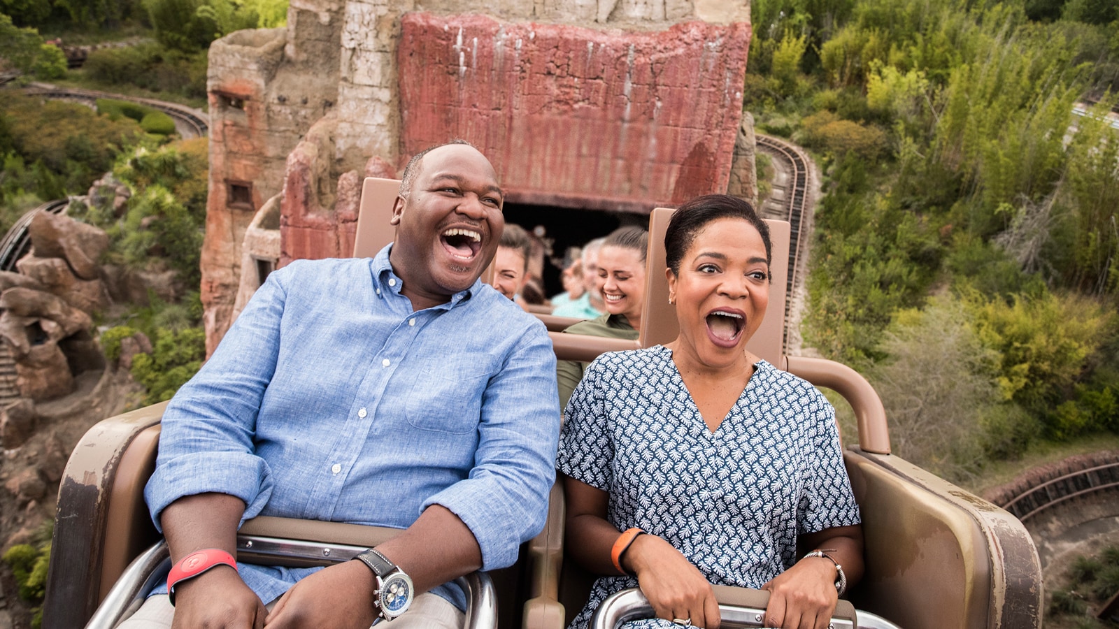 A man and woman screaming with joy while riding the Expedition Everest attraction