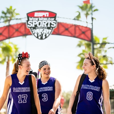 Three athlete Guests sharing a laugh as they walk through the ESPN Wide World of Sports Complex at Walt Disney World Resort 