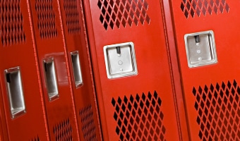 Five empty clothes lockers in a locker room