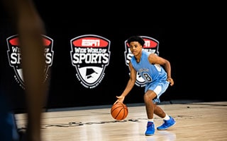 A teenager playing basketball on a court at the ESPN Wide World of Sports Complex