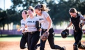 Softball players running out to the field at the ESPN Wide World of Sports Complex 