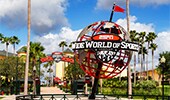 A large globe with a logo that reads ‘ESPN Wide World of Sports Complex’ stands at the entrance to ESPN Wide World of Sports at Walt Disney World Resort in Florida