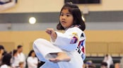 International Martial Arts Festival A girl in a gi performs a martial arts kick
