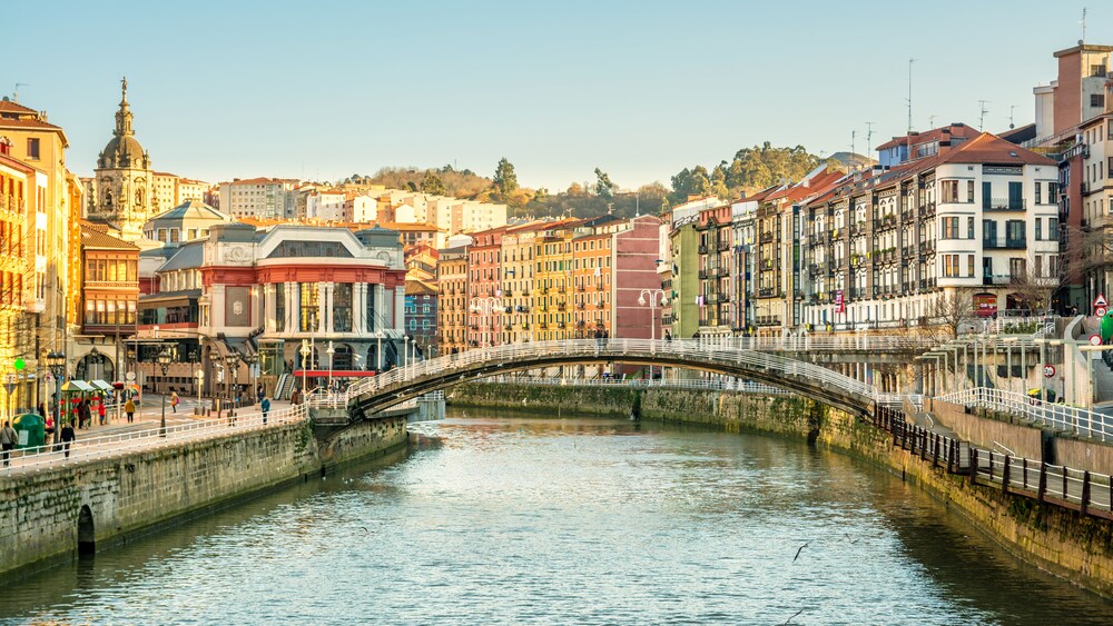 A bridge over a river that flows through a city