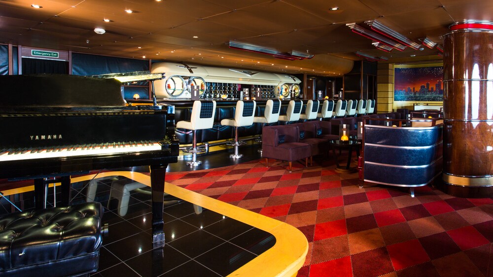 A microphone rests on a stand just above the top of a grand piano