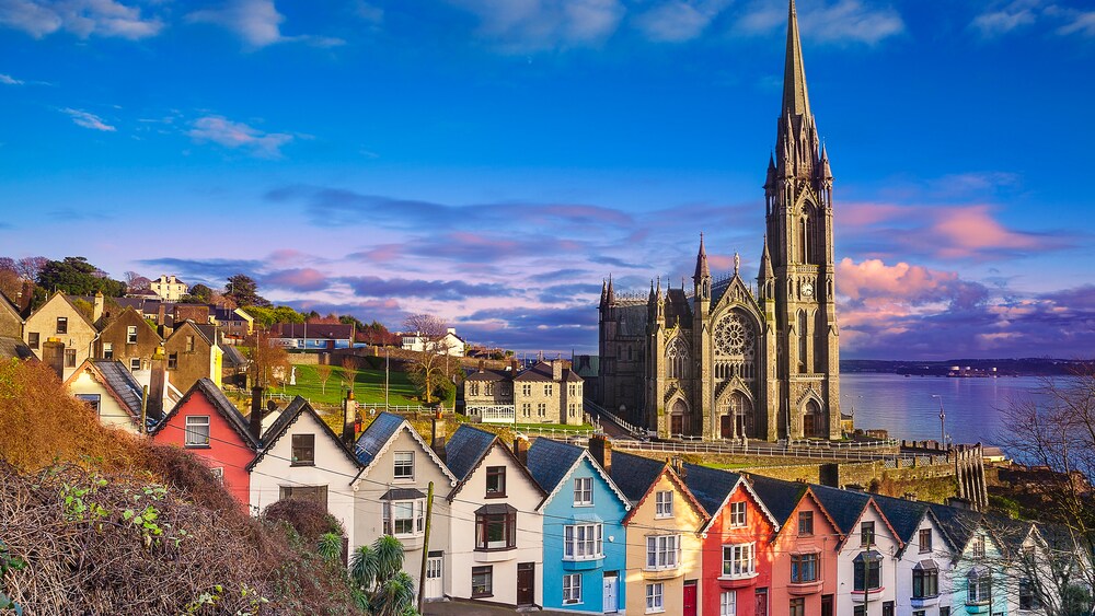 A row of houses poised in front of the Church of the Holy Rosary cathedral