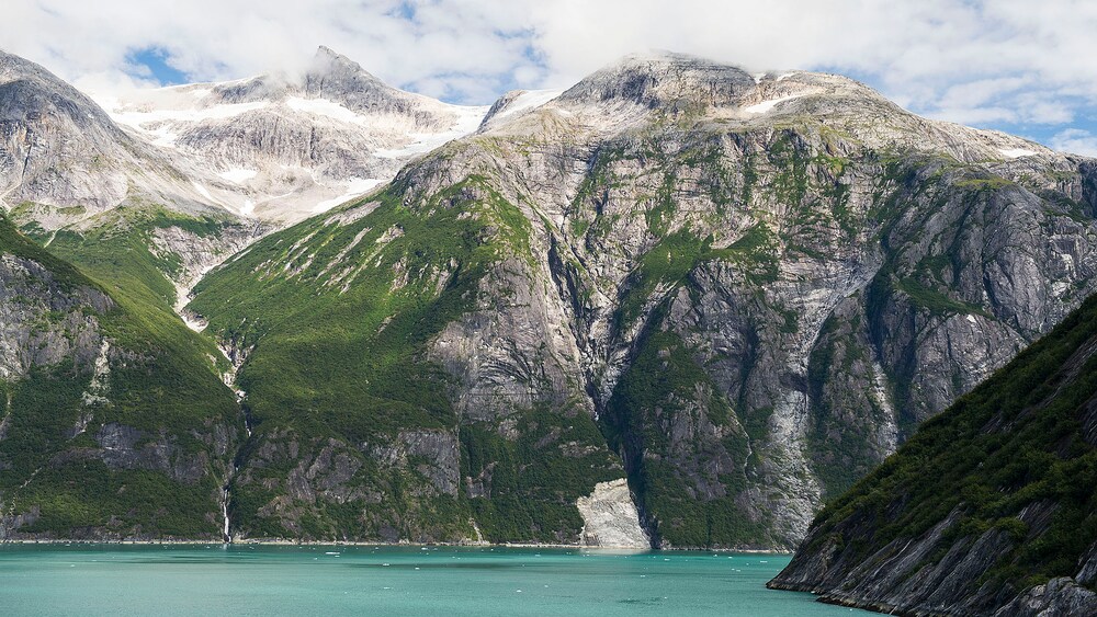 A mountain range near a lake