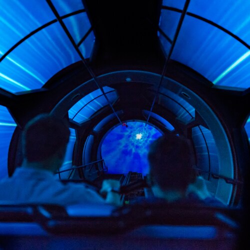 Guests enter a dark, mysterious tunnel while riding Hyperspace Mountain