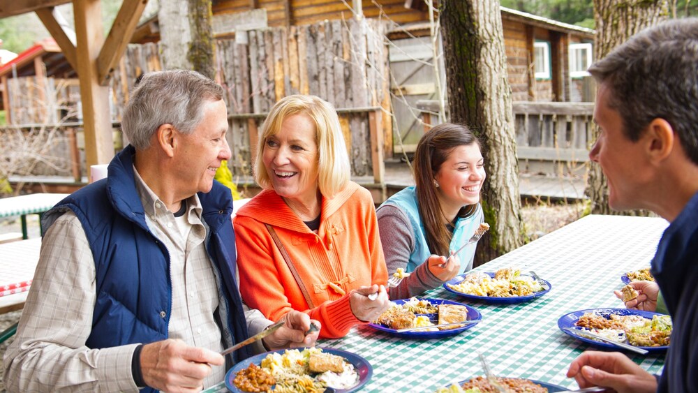 A family of 4 enjoying a traditional Alaskan meal