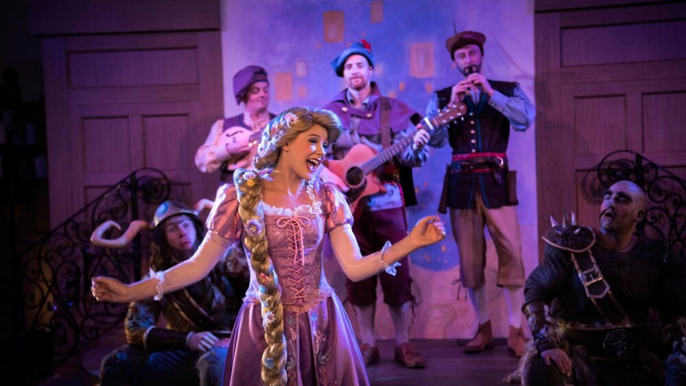 Rapunzel performs a song accompanied by musicians in costume